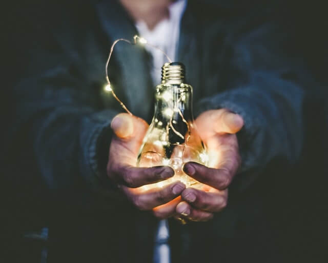 A person holding a lightbulb and fairy lights. I felt that this image showed energy-consciousness. This article is about how to save energy.