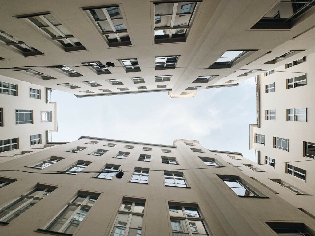 A picture that captures all four surrounding buildings towering over the photographer. This image should inspire the feelings of vertigo.